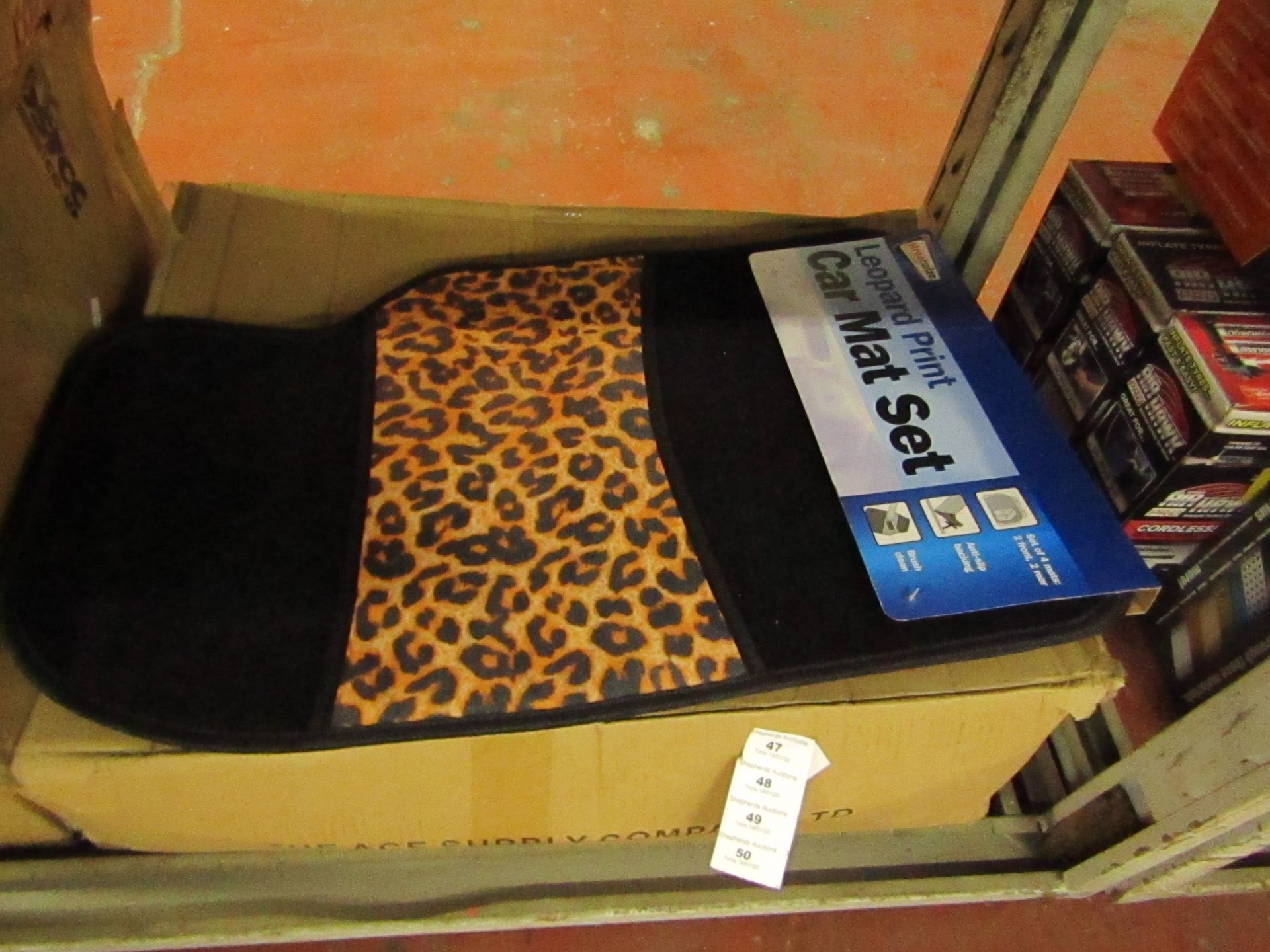 Set of 4 leopard print car mats, new and packaged.