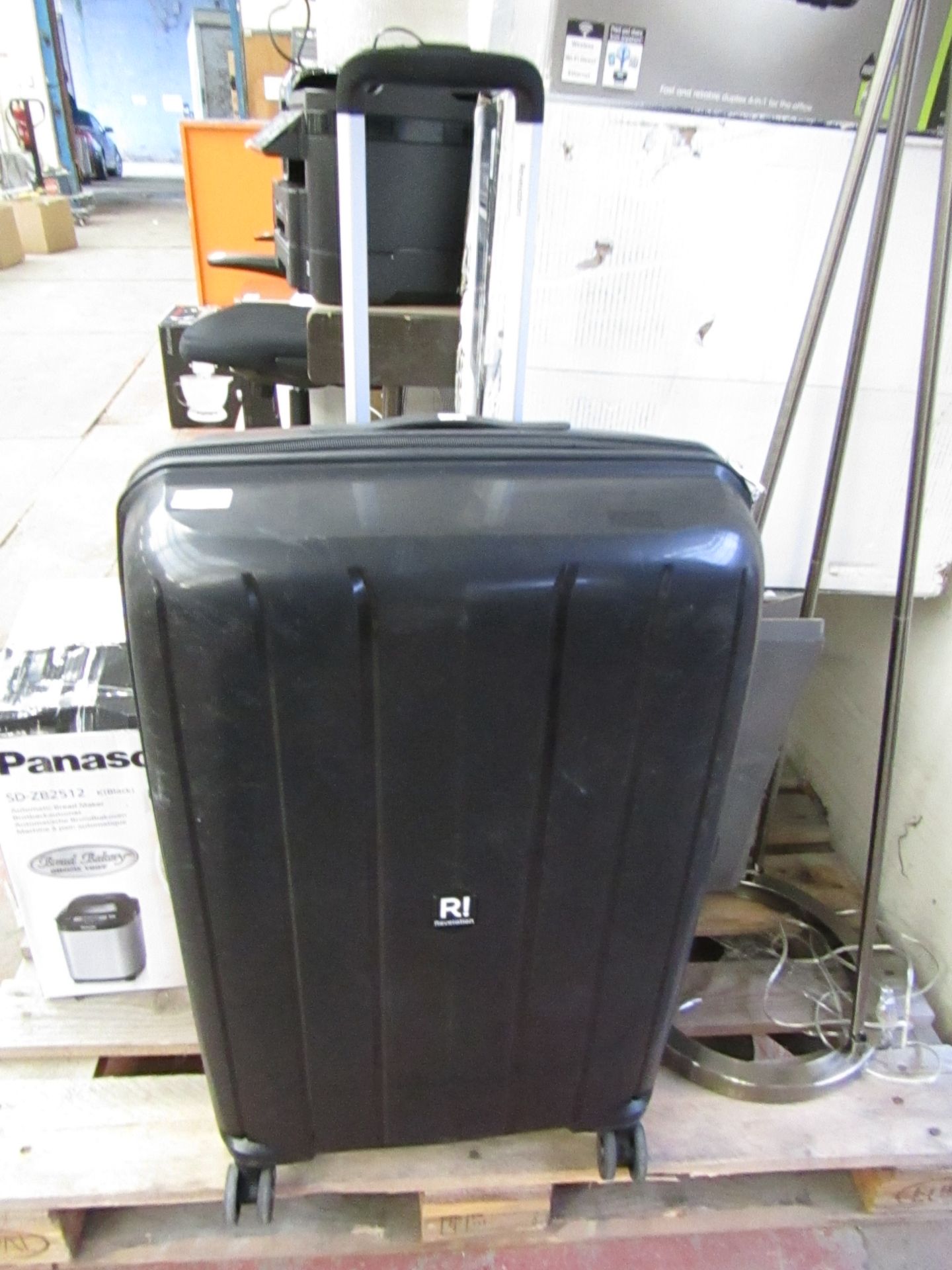 Large Revolution Suitcase on Wheels with Pull Out Handle. Has a few Scuffs but still Usable