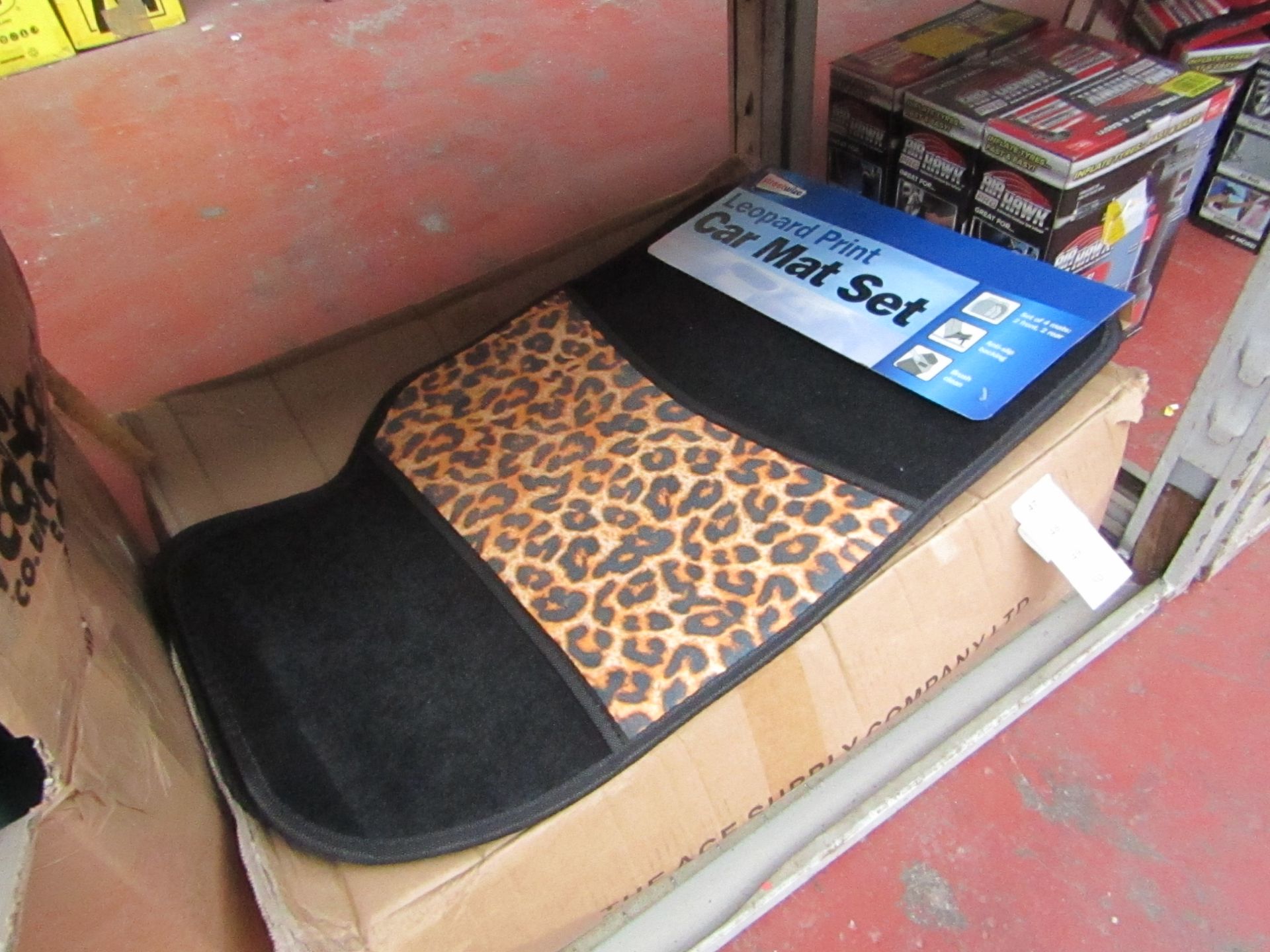 Set of 4 leopard print car mats, new and packaged.