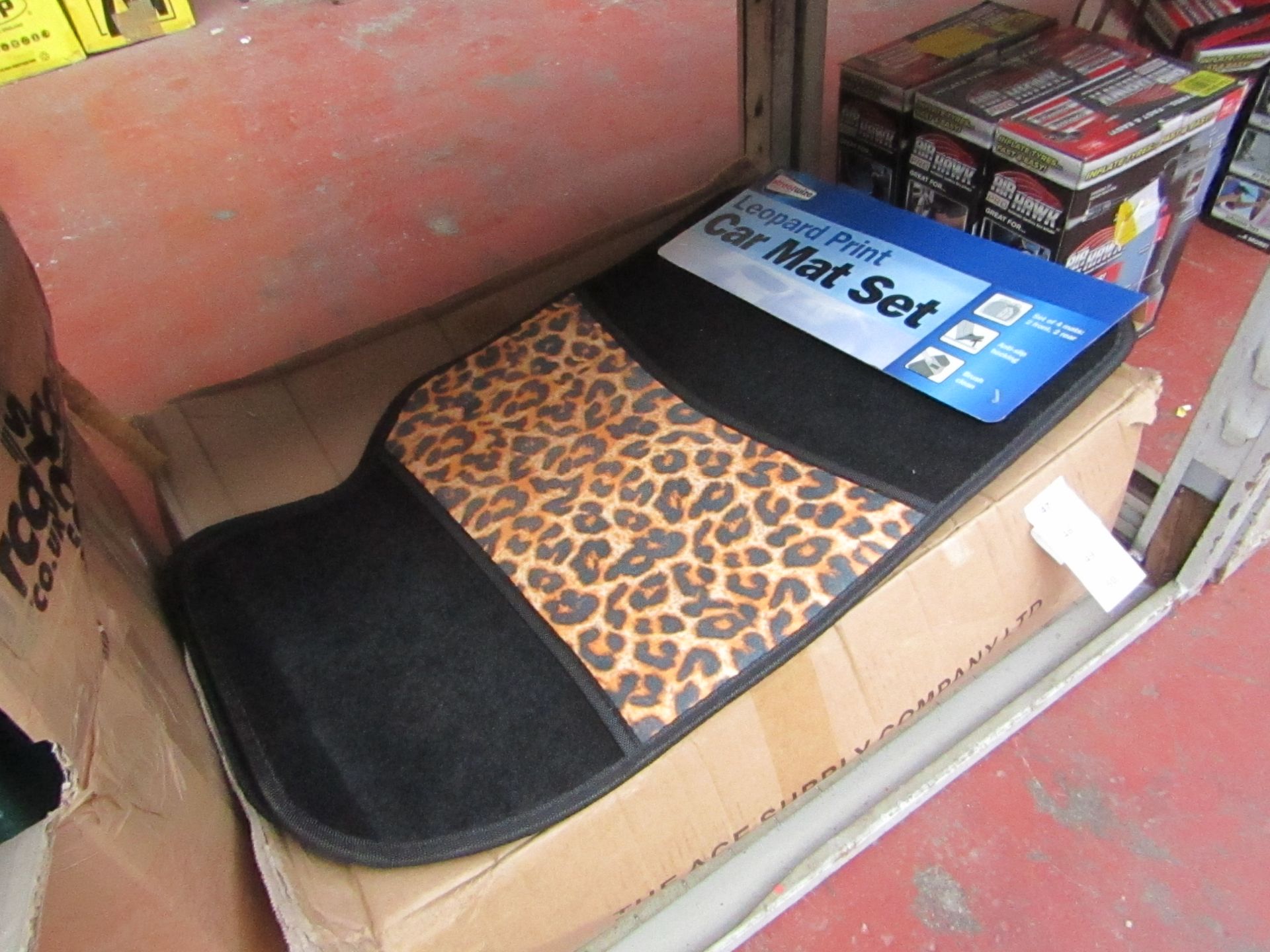 Set of 4 leopard print car mats, new and packaged.