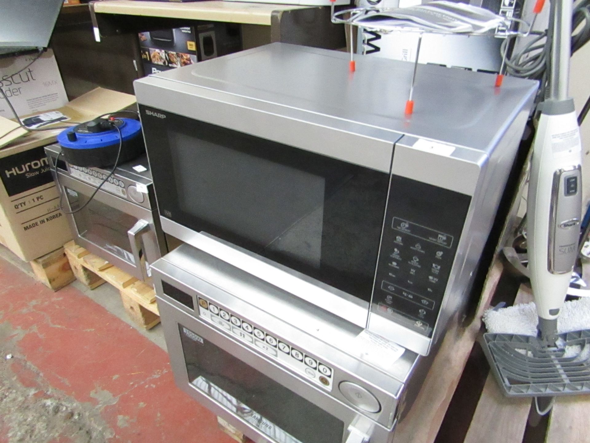 Sharp 900w Microwave Oven. Looks unused & Tested working. Has a dint on the top but no other damage