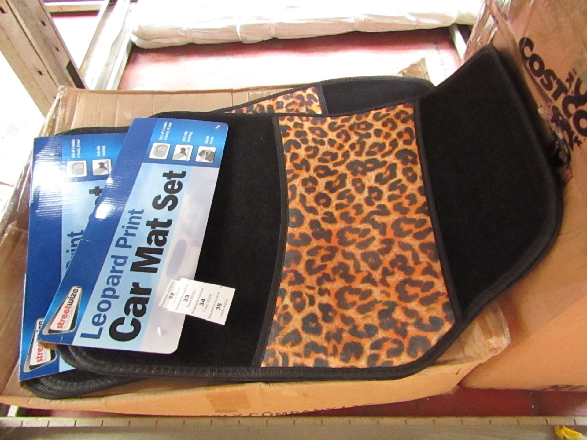 Set of 4 leopard print car mats, new and packaged.