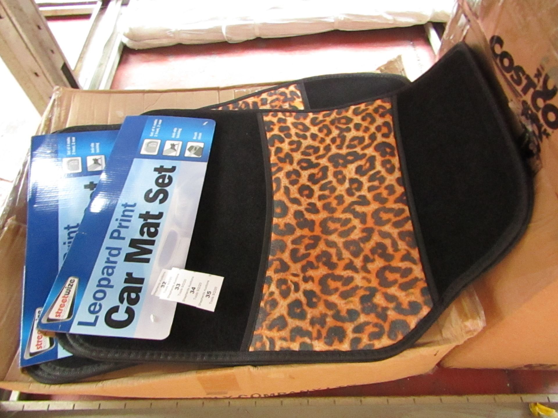 Set of 4 leopard print car mats, new and packaged.