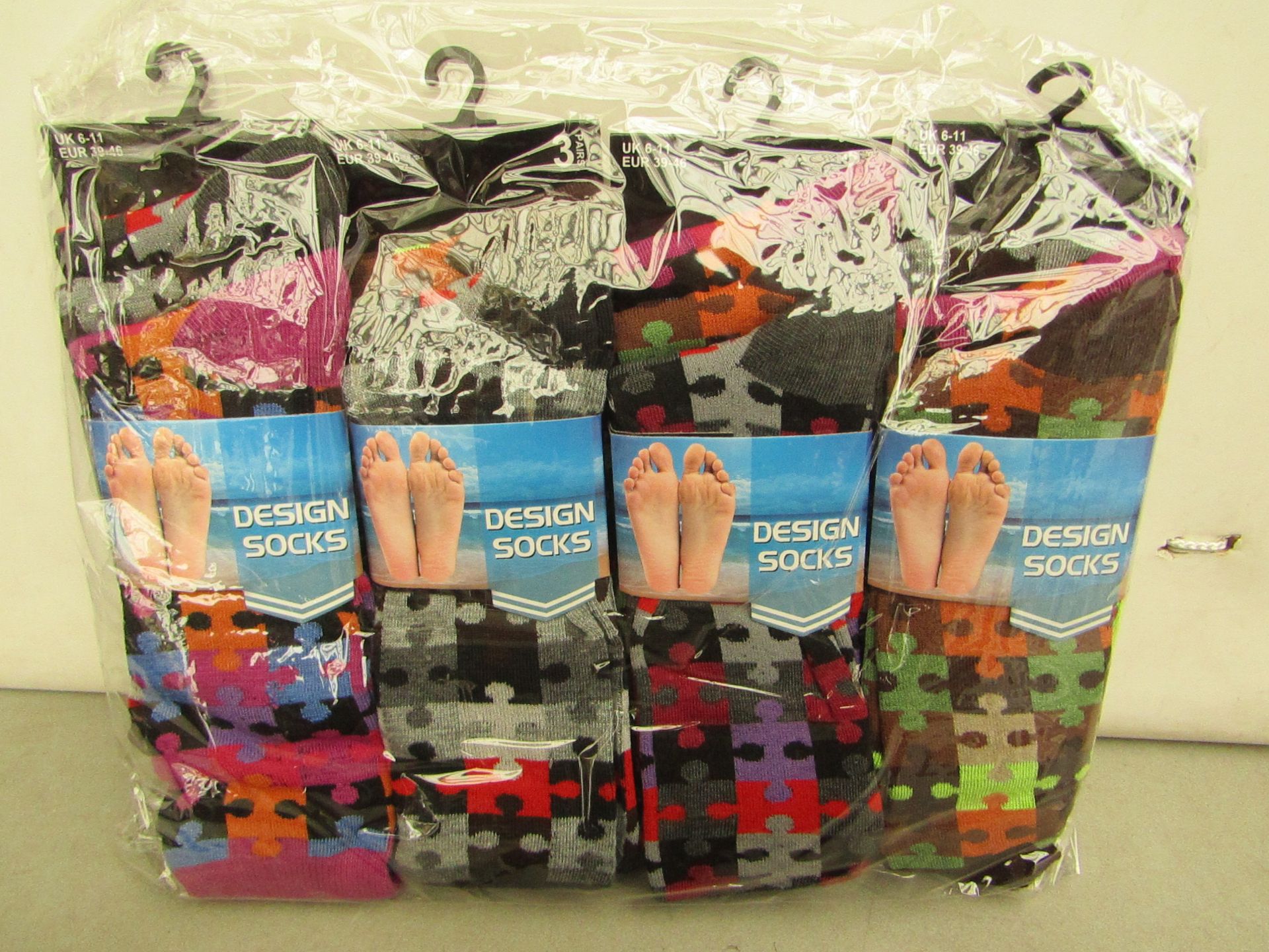 12x Pairs of design socks, size 6-11, new and packaged.