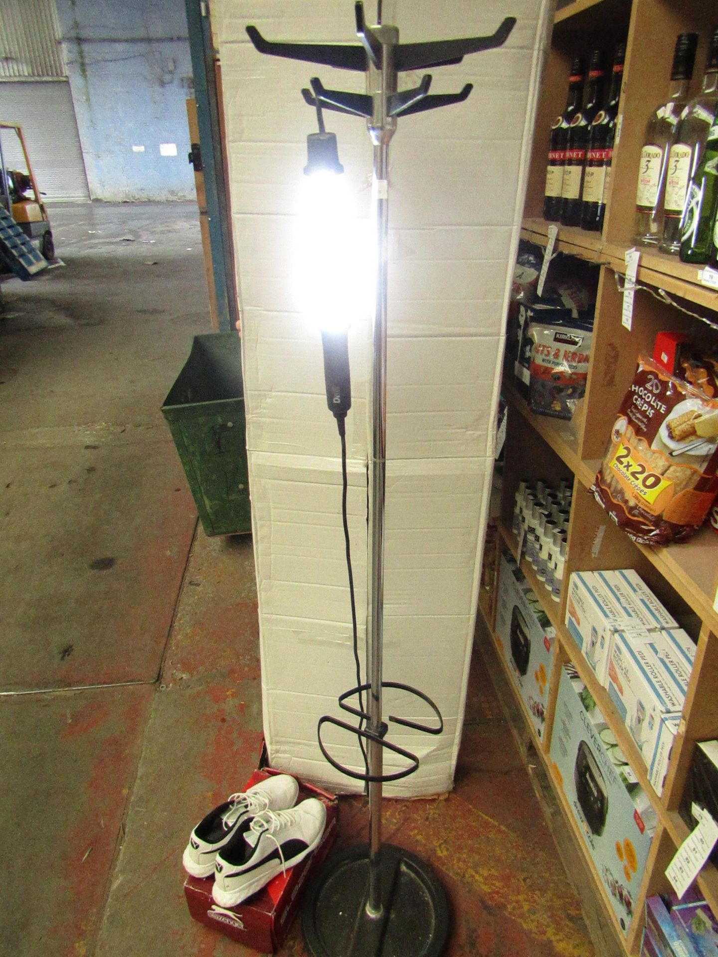 Coat rack with a pair of Slazenger shoes size 9 and Diall hand lamp.