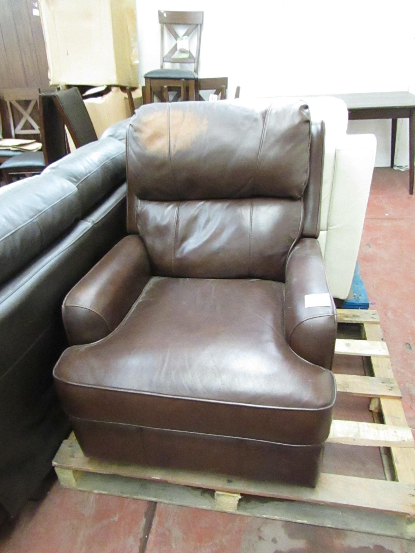 Leather Rocking manual reclining armchair, mechanism is working but there is a discoloured patch