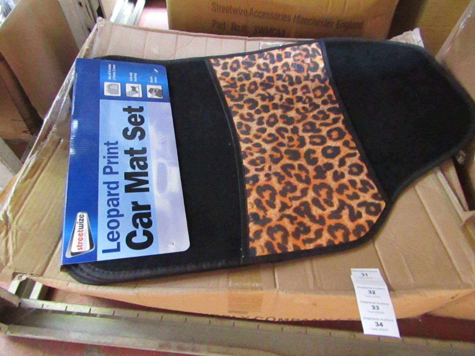 Set of 4 leopard print car mats, new and packaged.