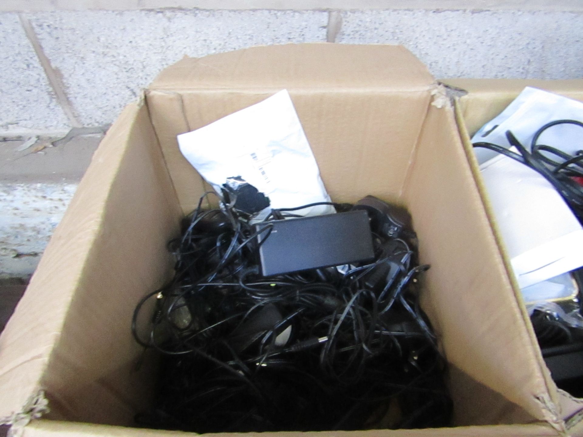 Box Of Various Items being : AC Power Adapters, Various Different Cables.