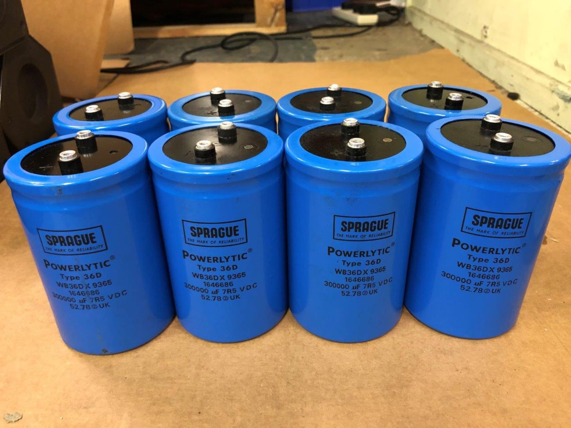 8 each Sprague Powerlytic 300,000µF 7.5V Electrolytic capacitors in box.