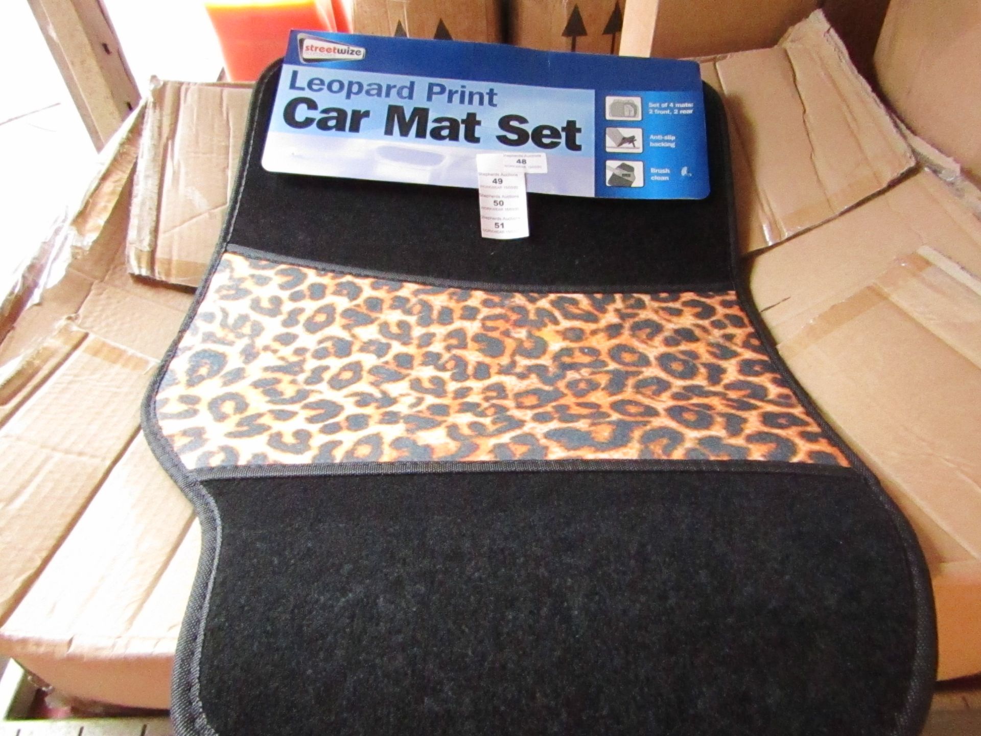 Set of 4 leopard print car mats, new and packaged.