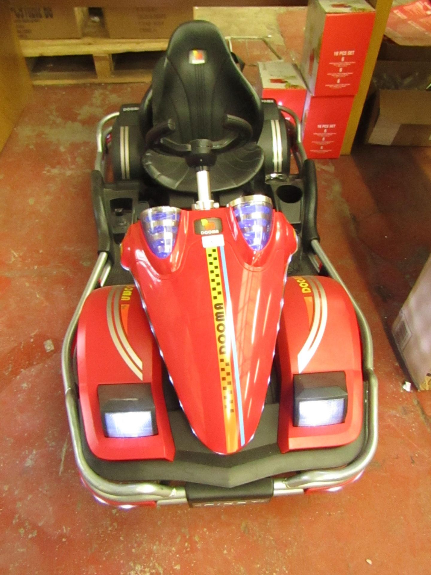 Dooma kids electric go kart with various functions, tested working but missing driving pole. RRP