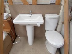 Cloak room toilet set that includes a unbranded Roca close coupled toilet complete with seat and