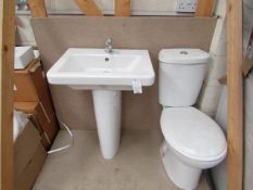 Cloak room toilet set that includes a unbranded Roca close coupled toilet complete with seat and