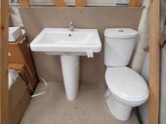 Cloak room toilet set that includes a unbranded Roca close coupled toilet complete with seat and