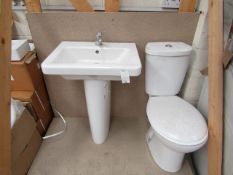 Cloak room toilet set that includes a unbranded Roca close coupled toilet complete with seat and