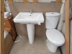 Cloak room toilet set that includes a unbranded Roca close coupled toilet complete with seat and