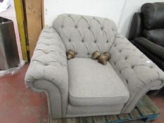 Grey Fabric Button Back arm chair with wooden feet.
