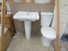 Cloak room toilet set that includes a unbranded Roca close coupled toilet complete with seat and