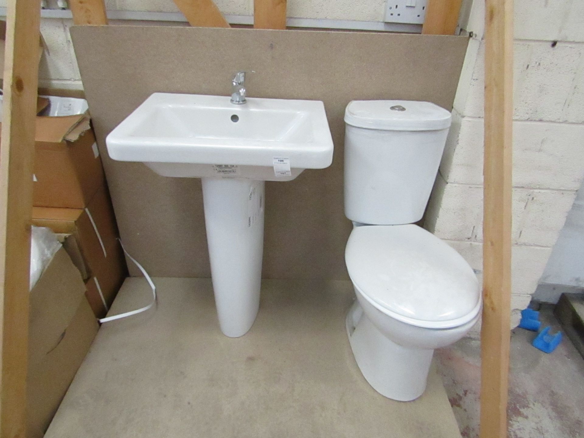 Cloak room toilet set that includes a unbranded Roca close coupled toilet complete with seat and