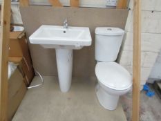 Cloak room toilet set that includes a unbranded Roca close coupled toilet complete with seat and