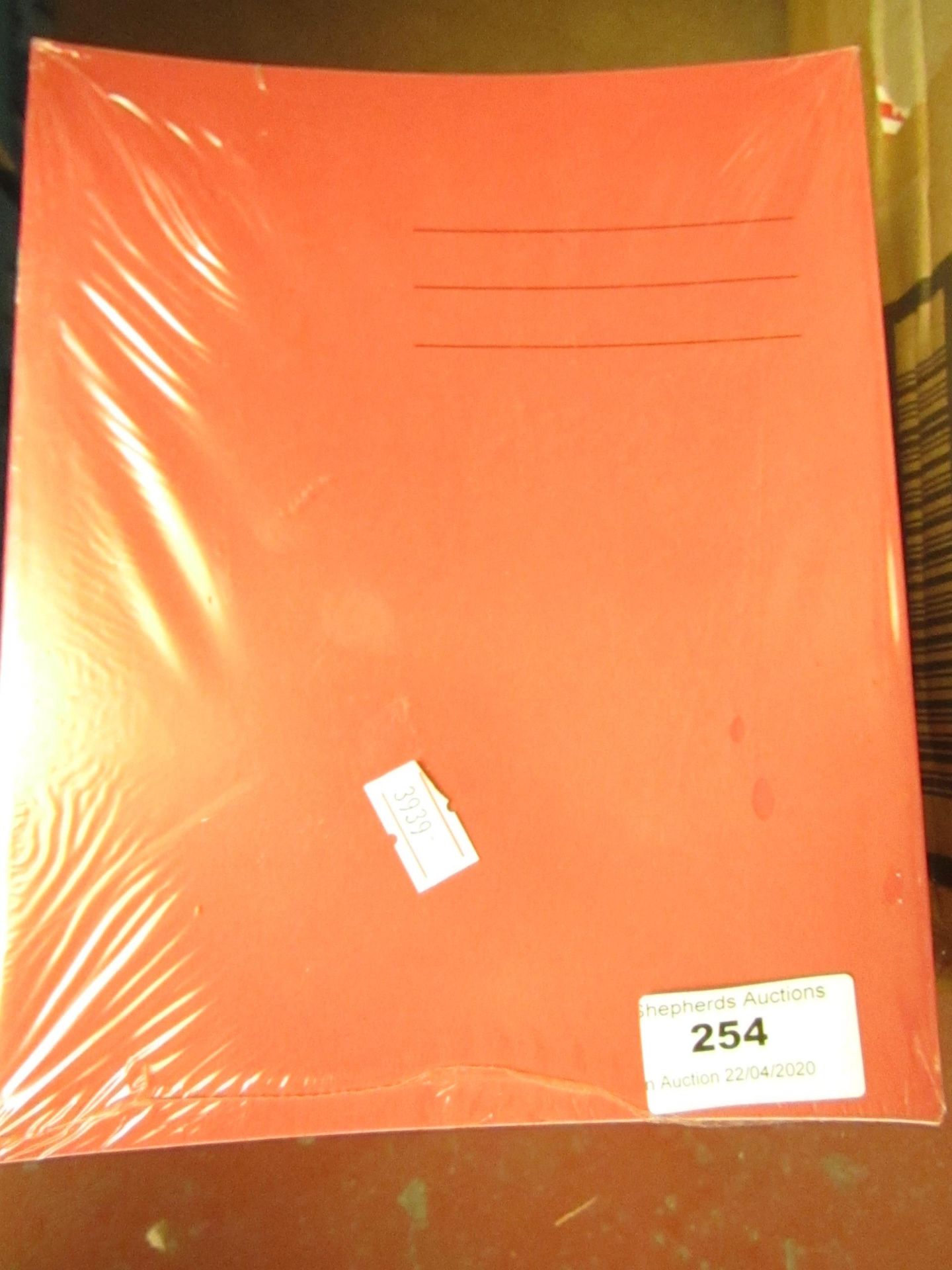 Approx 60x red coloured exercise books, new and packaged.