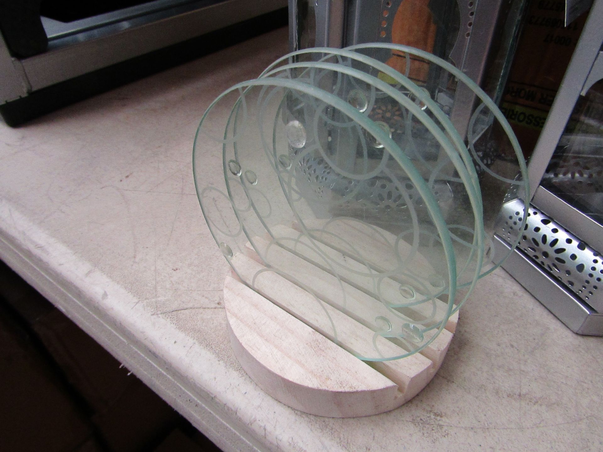 Set of 4x glass coasters with stand, new and packaged.