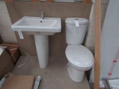 Cloak room toilet set that includes a unbranded Roca close coupled toilet complete with seat and