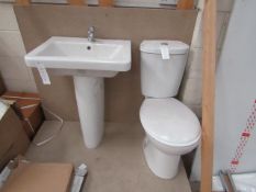 Cloak room toilet set that includes a unbranded Roca close coupled toilet complete with seat and