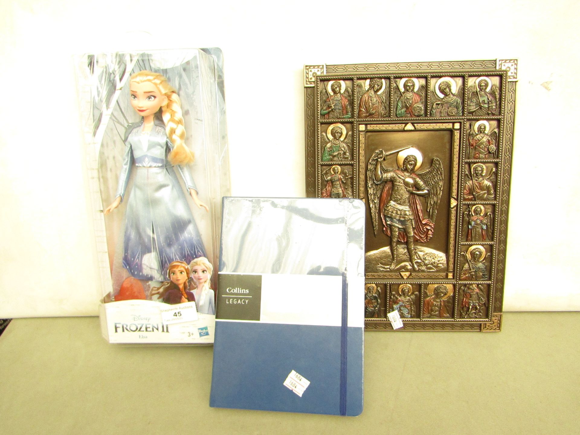 3 Items Being a Frozen Doll, Collins Notebook & a Wll Plaque. All unused