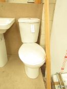 Cloak room toilet set that includes a unbranded Roca close coupled toilet complete with seat and