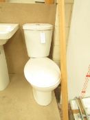 Cloak room toilet set that includes a unbranded Roca close coupled toilet complete with seat and