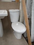 Cloak room toilet set that includes an unbranded Roca close coupled toilet complete with seat and