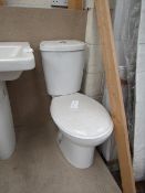 Cloak room toilet set that includes an unbranded Roca close coupled toilet complete with seat and