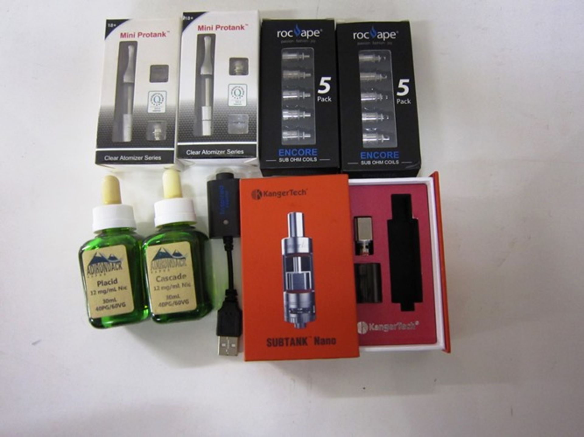 Mixed lot of miscellaneous e cigarette tanks, coils e liquids PS no tank in the Kanger sub box