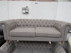 Chesterfield style 2 seater button back sofa, has a small rip on the front of one arm and is a bit