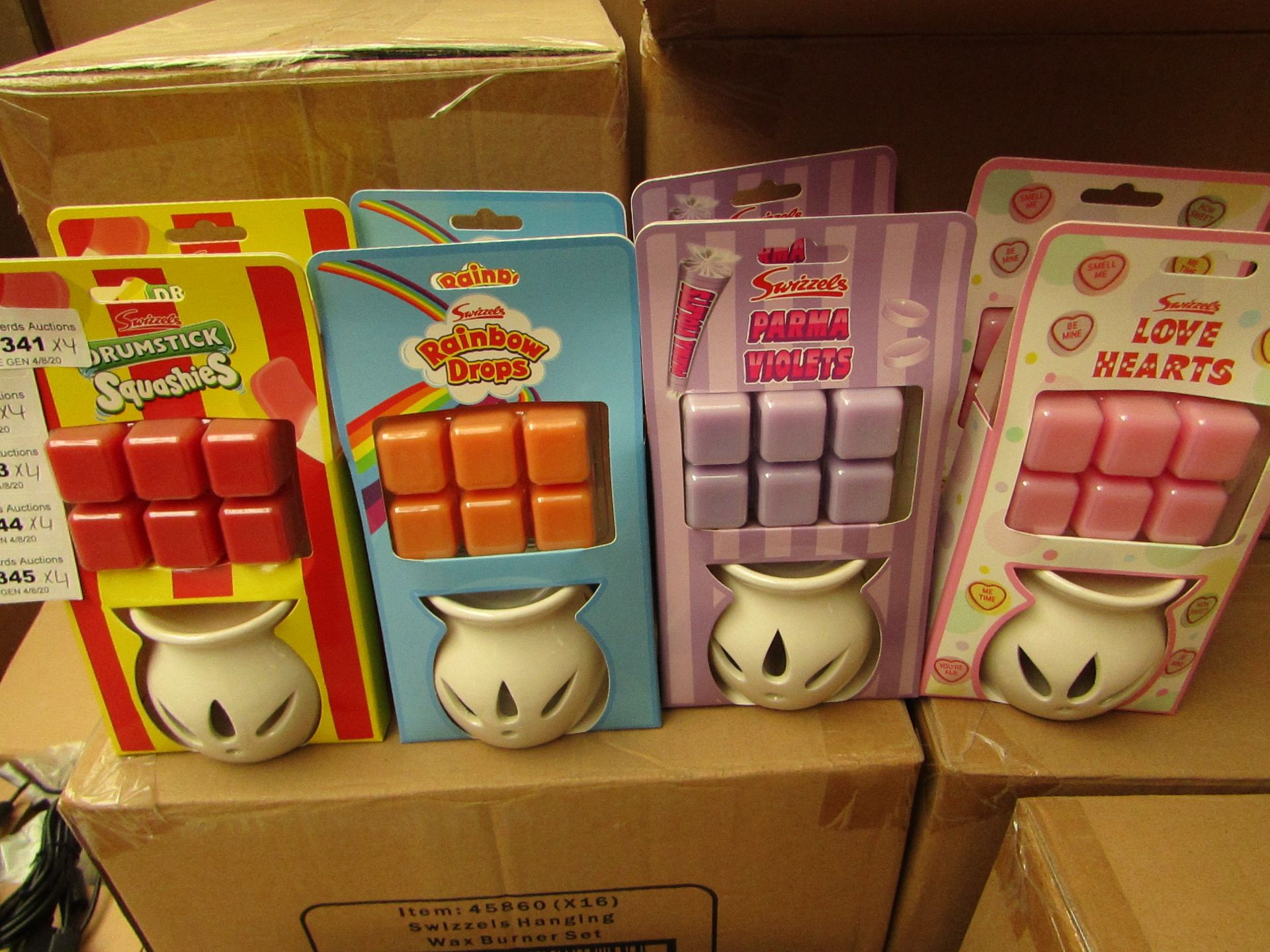 16 x Swizzles Wax Melt Burners with melts. 4 x Drumstick Squashies, 4 x Rainbow Drops, 4 x Parma