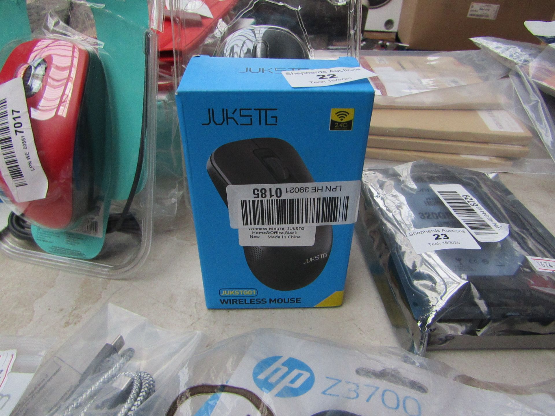 JUKSTG wireless mouse, unchecked and boxed.