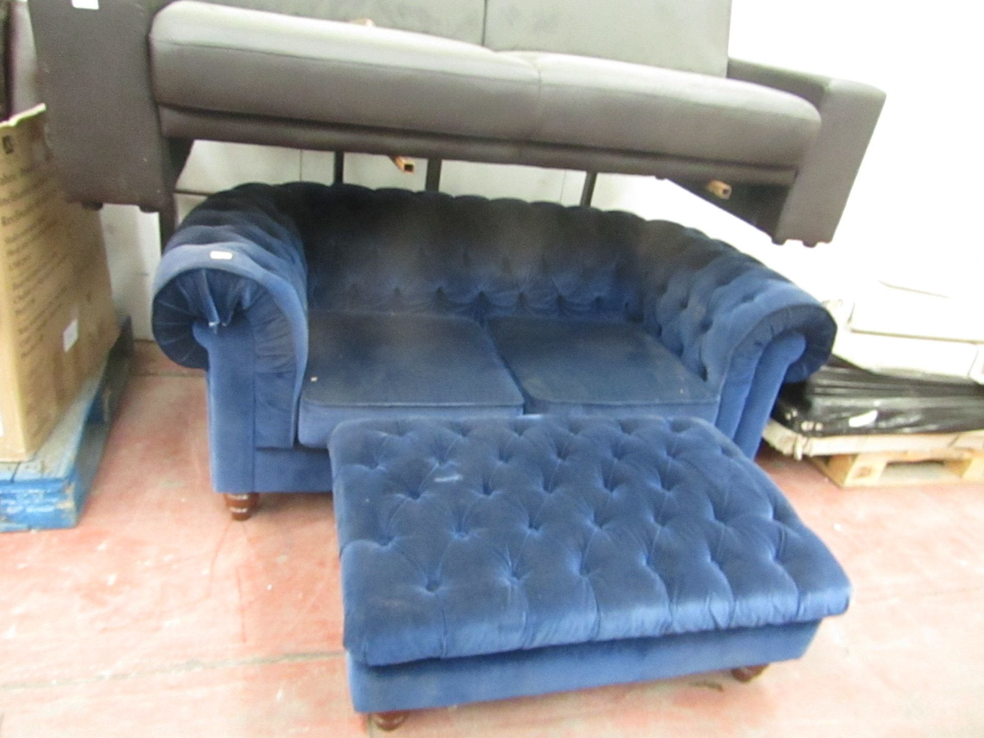 2 Seater Chester field stlye blue Velvet sofa with matching foot stool, the sofa has damage on one