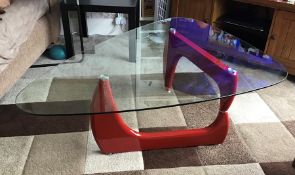 Clear glass coffee table with glossy red legs, brand new and boxed.