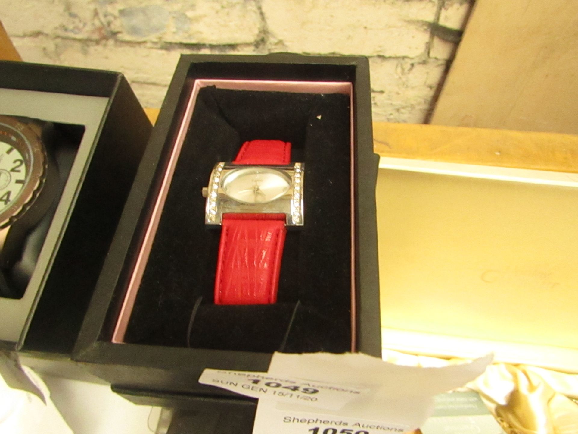 RJM Ladies red strapped watch, in presentation box, unchecked for working condition but looks