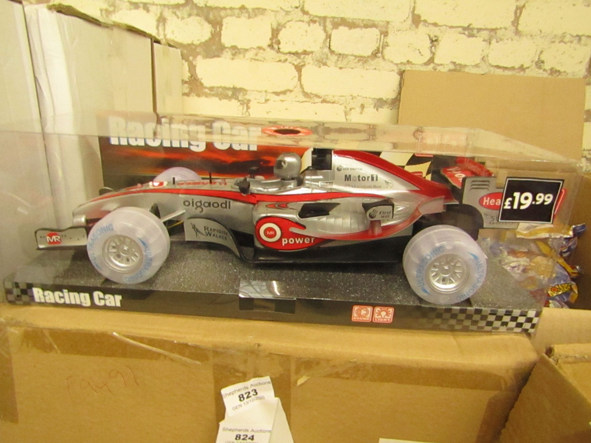 Lights and sounds Racing car, unused in packaging.