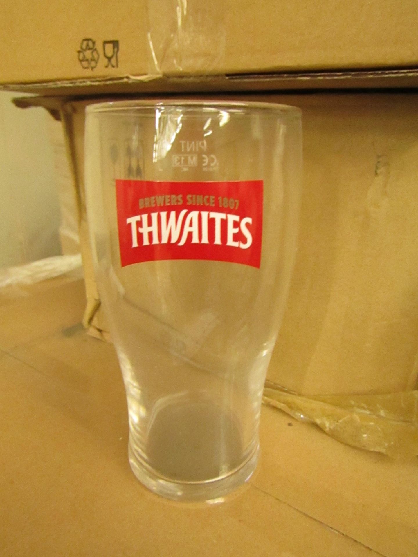 Box of 12 Thwaites pint glasses, new and boxed