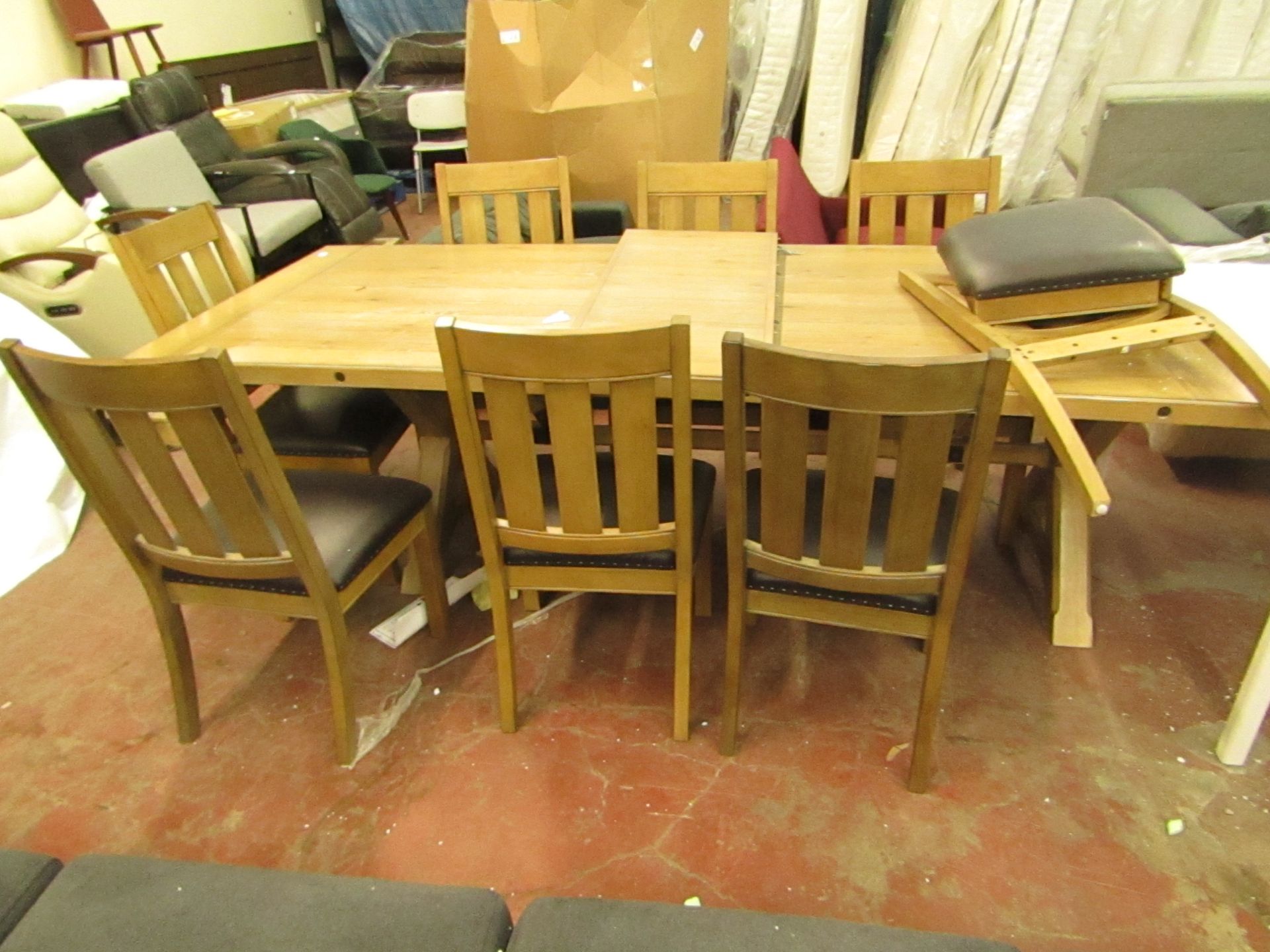 Large Costco 9 Piece dining table set, includes 8 chairs (one dismantled and unchecked) and a