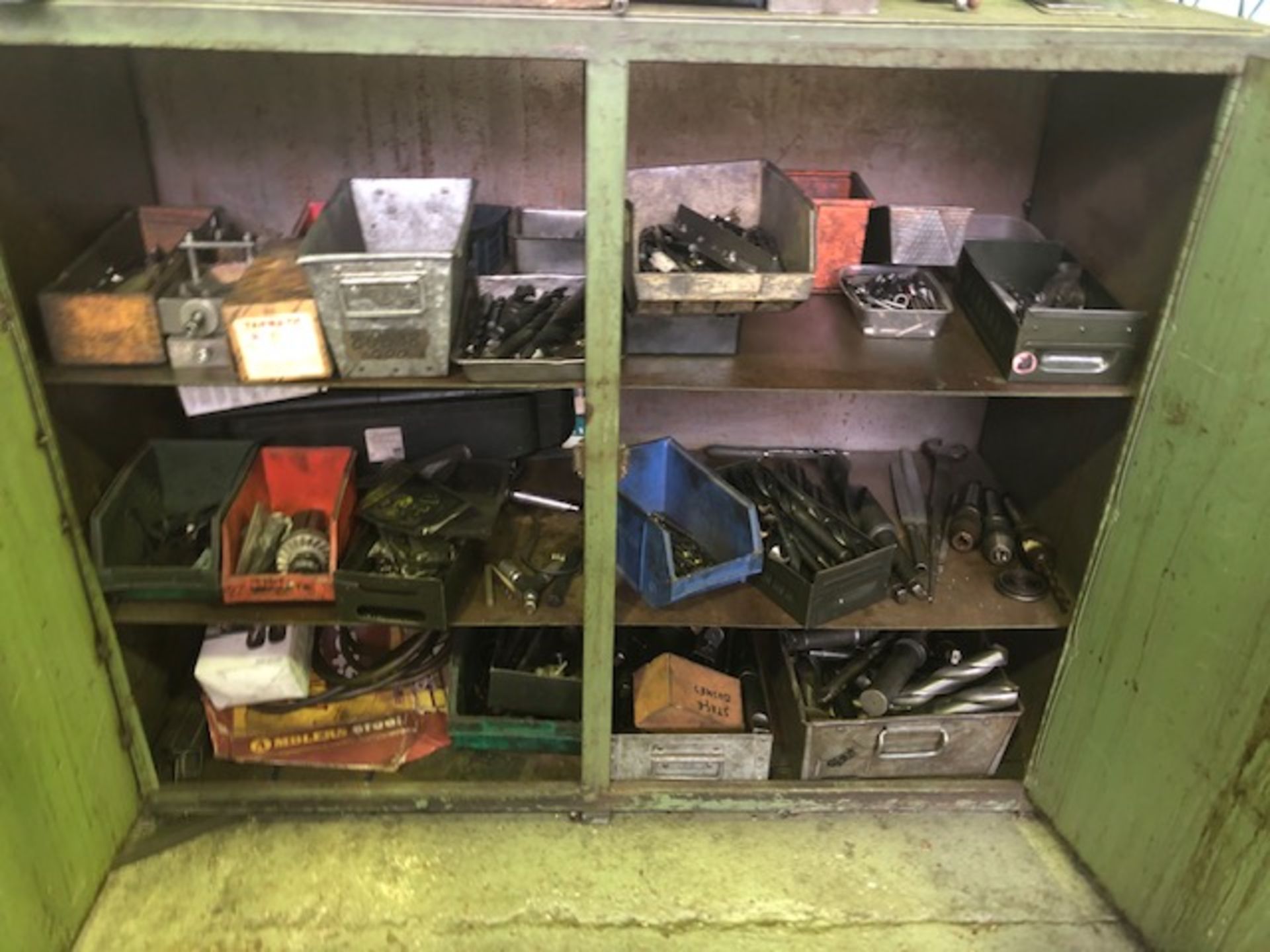 Steel cabinet including large quantity of drill bits and associated tooling