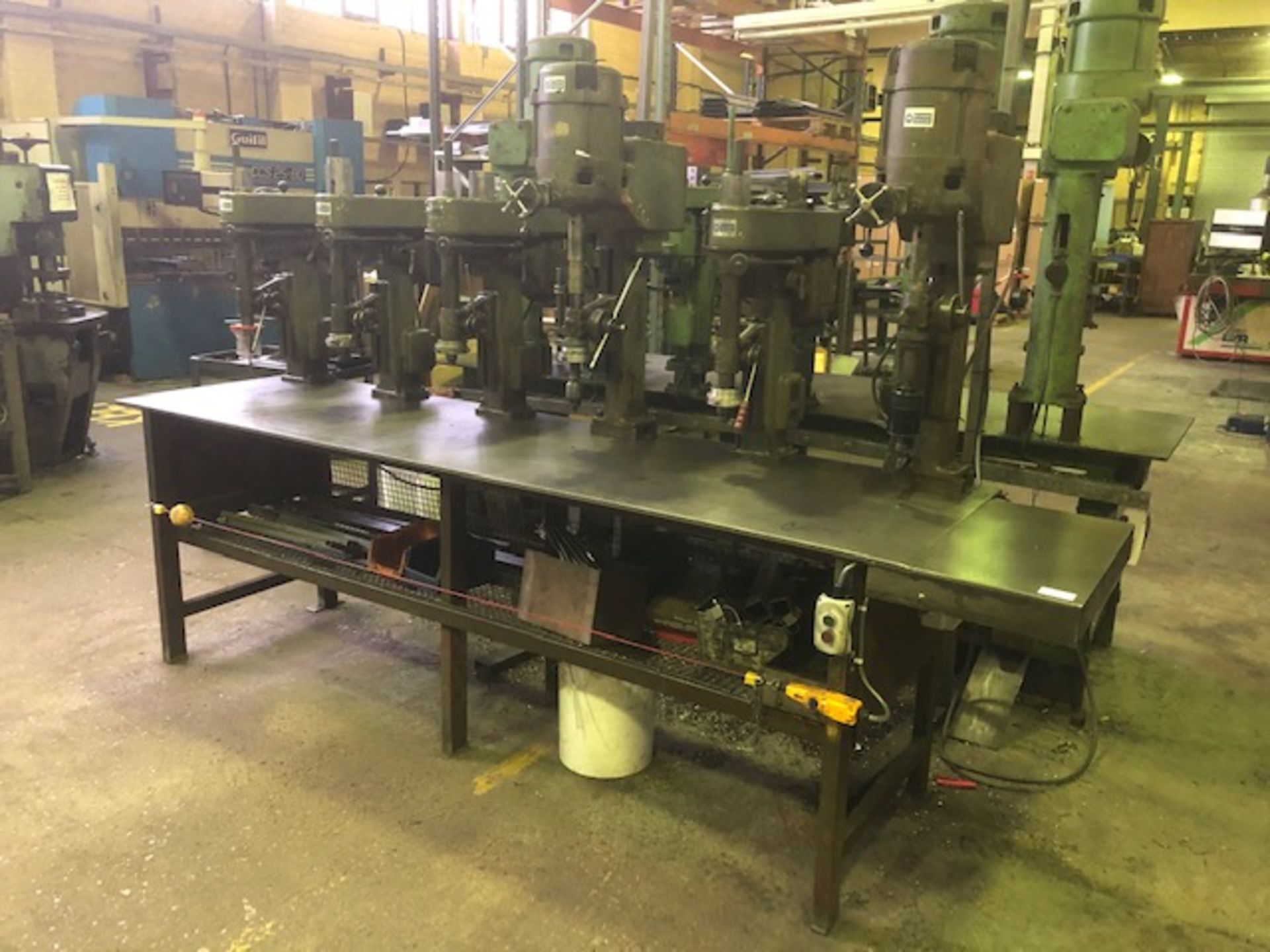 Steel drill bench with 6 overhead pillar drill units