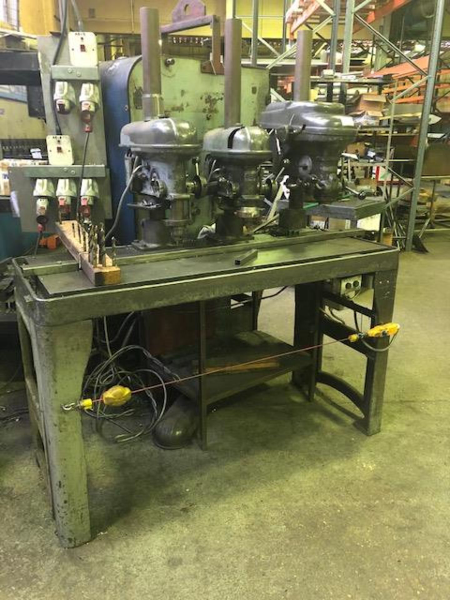 Triple head steel drill bench with quantity of associated drill bits