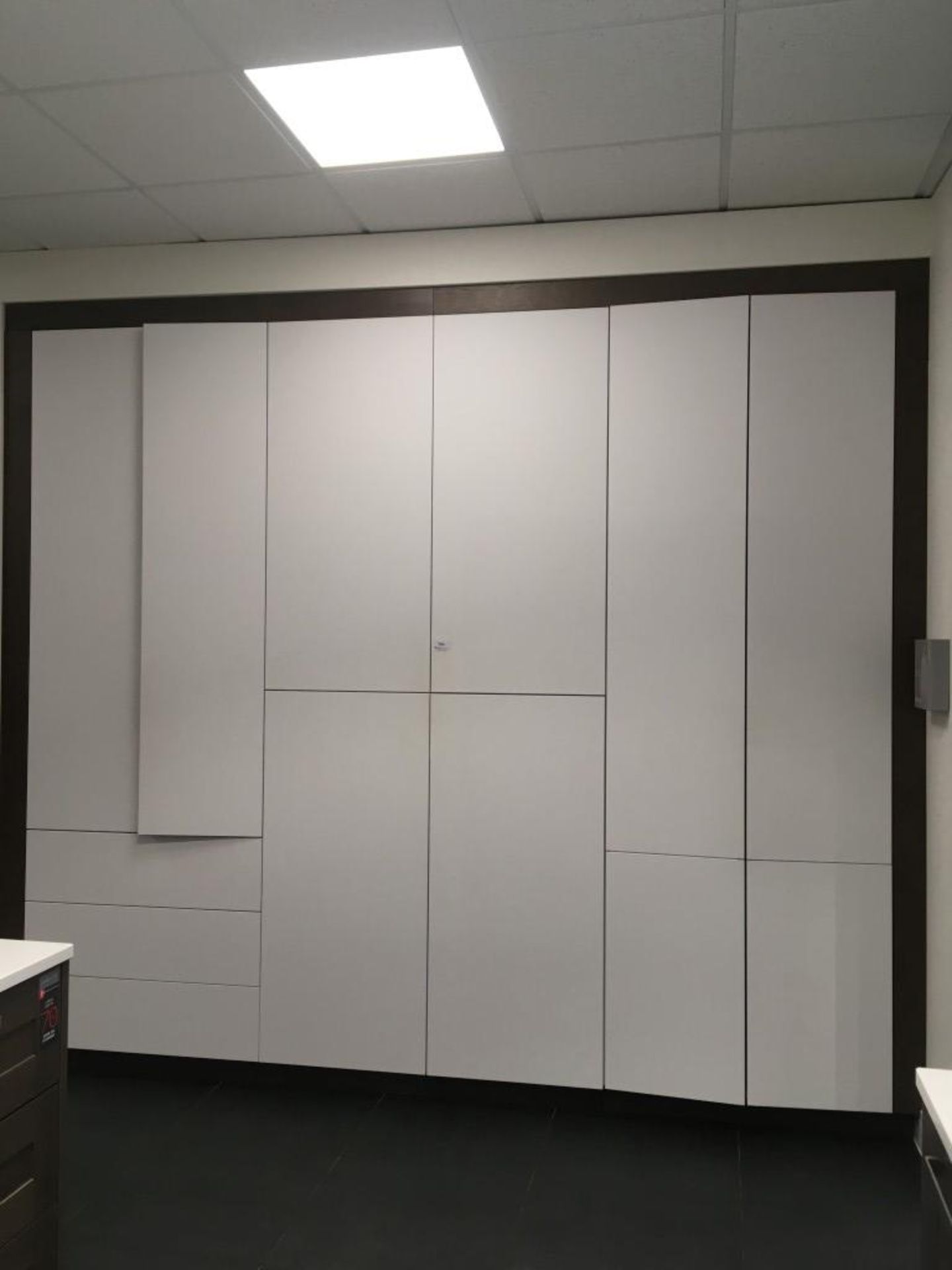 White laminate 8' wall mount storage unit including integrated soft close six drawer unit