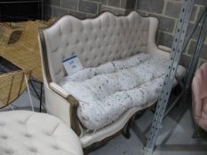 Wooden framed button back Regency style sofa with circular foot stool, please note missing seat cove