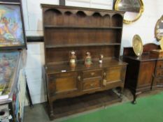 Oak dresser with 2 open shelves over 2 cupboards flanking 2 drawers & display shelf beneath.