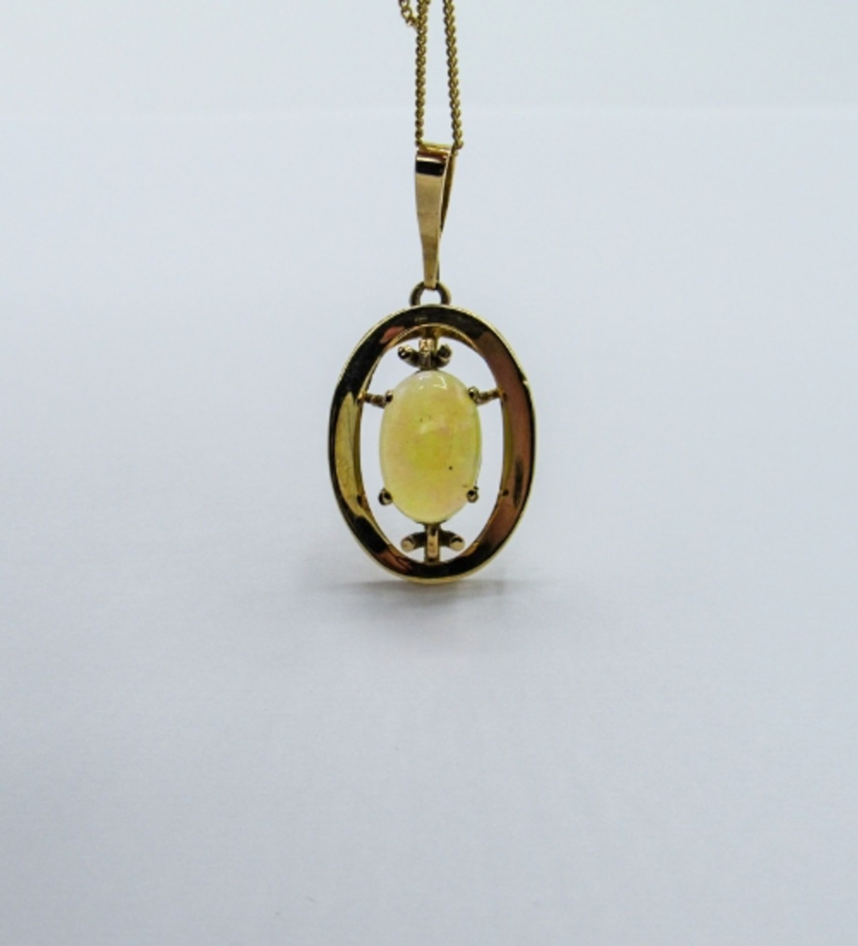 9ct gold opal pendant on a 9ct gold chain, weight 5.7gms. Estimate £325-350